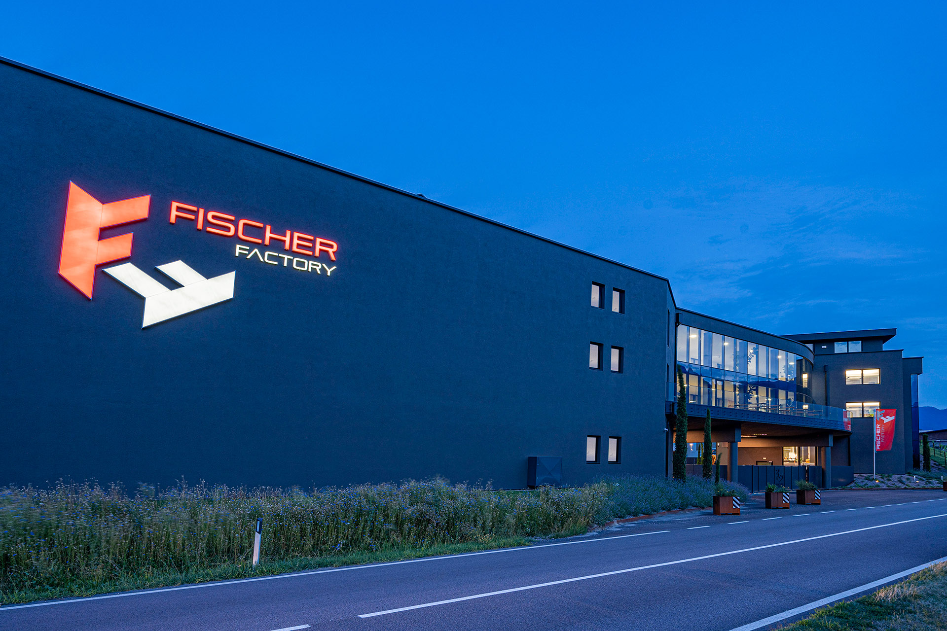 Fischer Factory illuminated facade at dusk